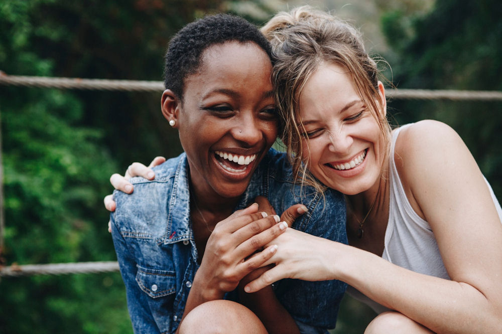 Woman embracing girlfriend during break in addiction treatment